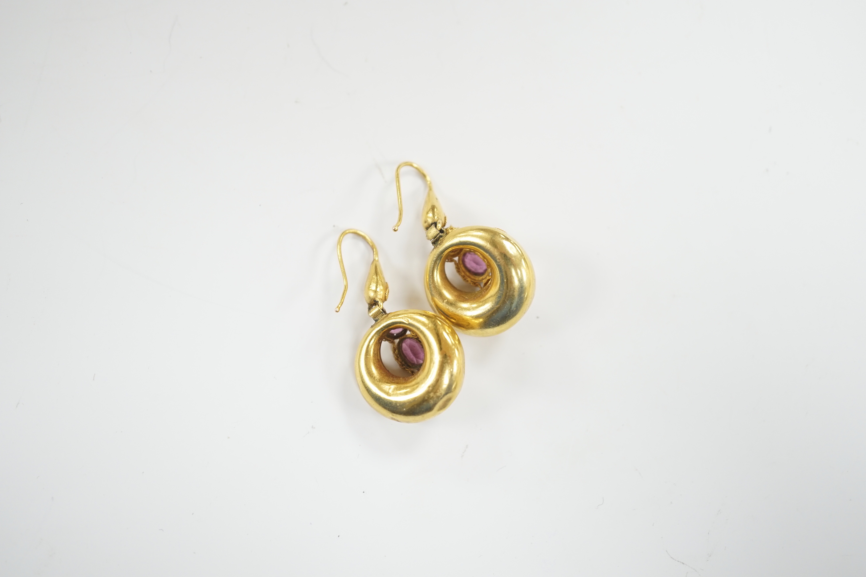 A pair of Victorian yellow metal canetile work and three stone garnet set drop earrings, overall 35mm, gross weight 4.1 grams.